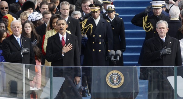 Vice President Joe Biden, left, President Barack Obama, and former President George W. Bush, right, sing the national anthem at the end of the swearing-in ceremonies at the U.S. Capitol in Washington, Jan. 20, 2009. Photo by Ron Edmonds/Associated Press. 